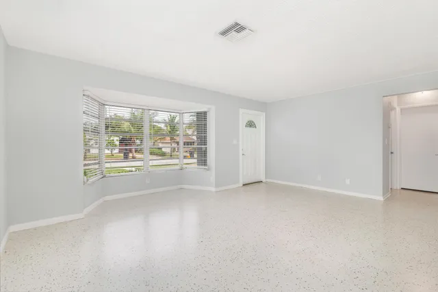 a view of an empty room with a window