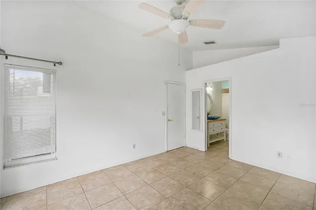 a bathroom with a shower and a ceiling fan