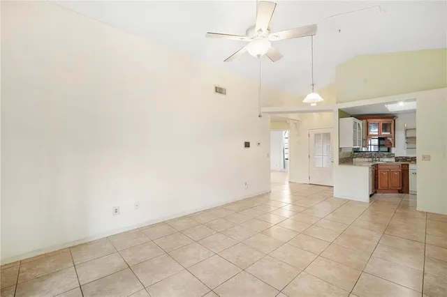 a view of a kitchen with a sink and a chandelier fan