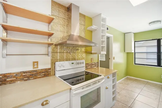 a kitchen with stainless steel appliances granite countertop a stove and a refrigerator