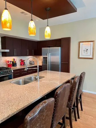 a kitchen with cabinets and stainless steel appliances