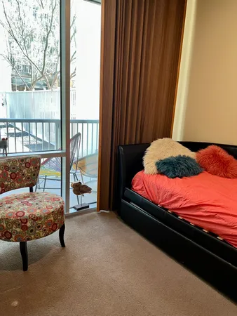 a bedroom with a bed and large window