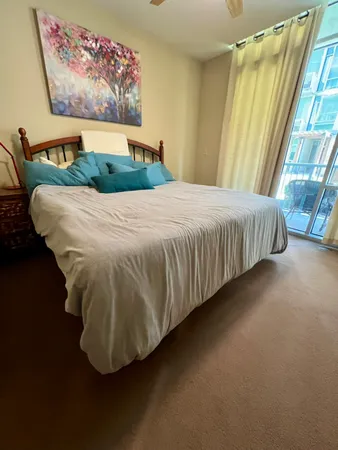 a bed sitting in a bedroom next to a window