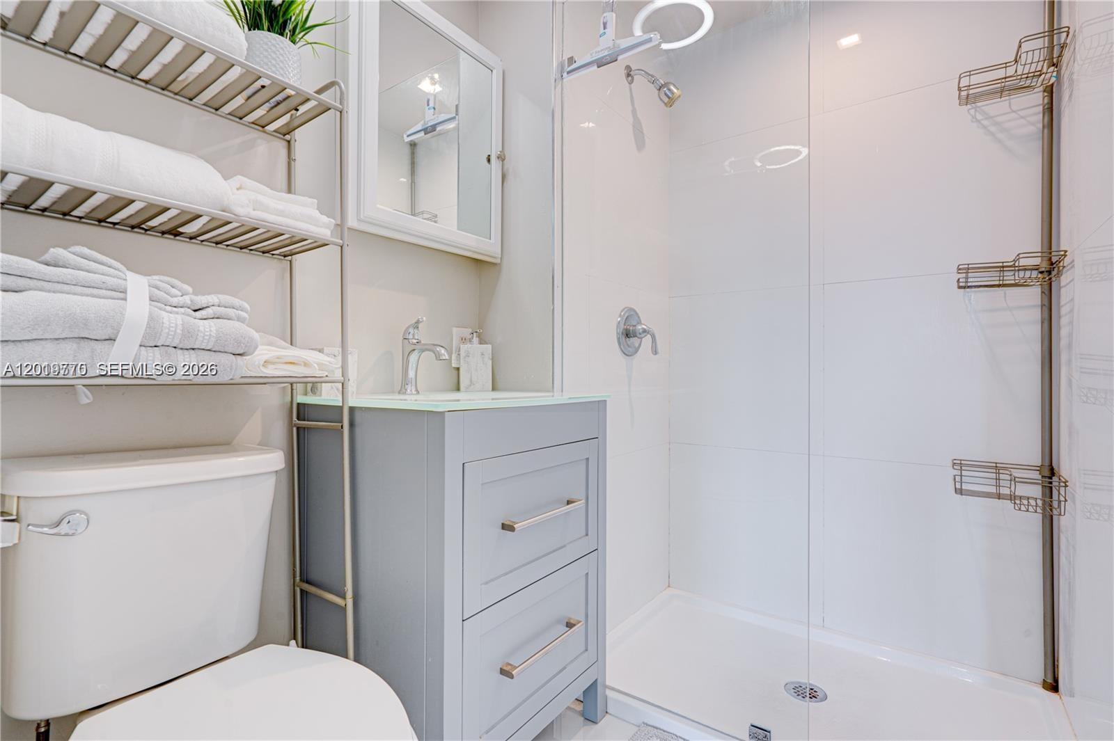 227 Southwest 30th Avenue, Unit B Miami, FL 33135 - Photo 8 of 15 a bathroom with a sink a toilet and shower