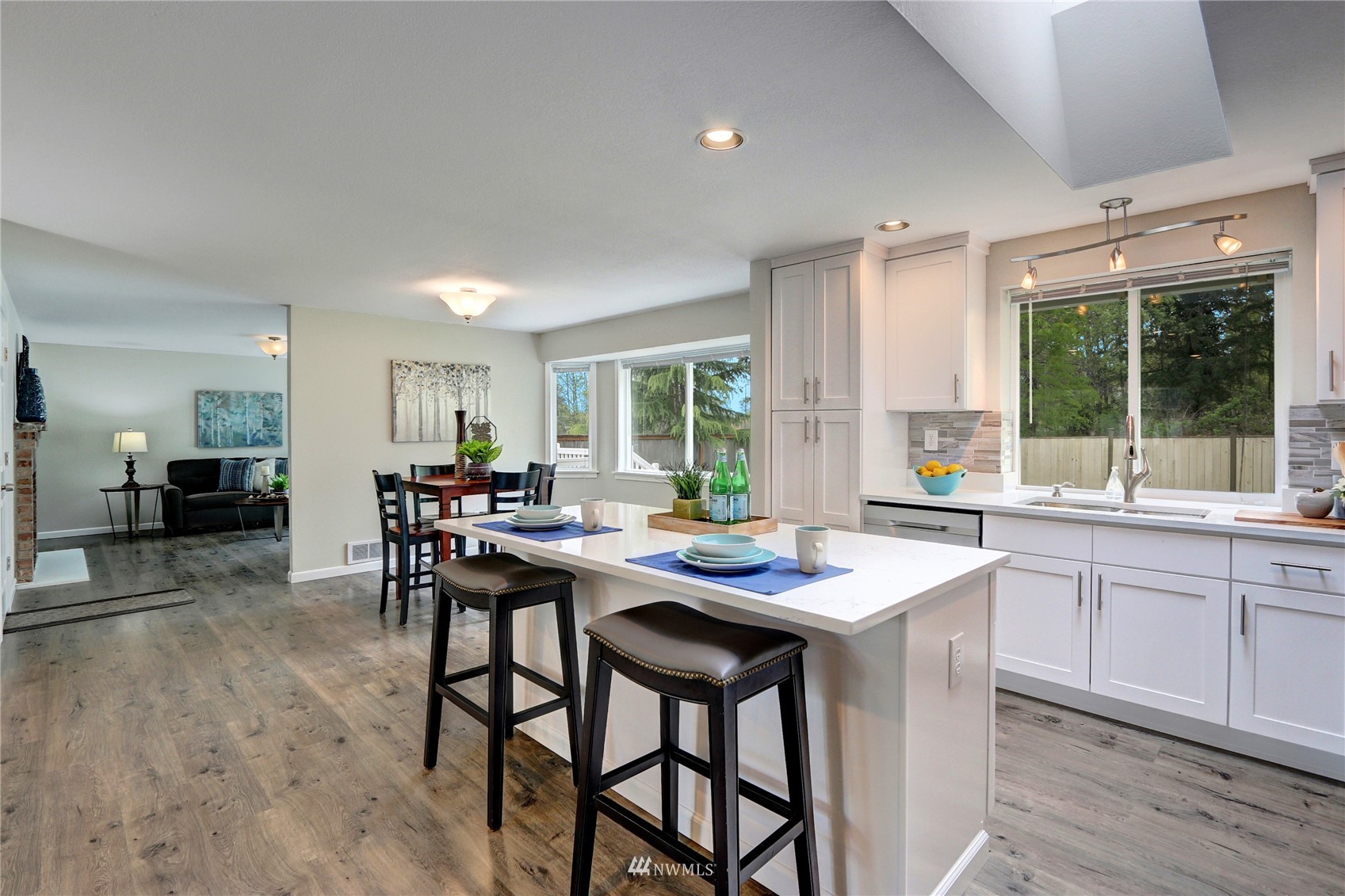 1412 234th Street Southwest Bothell, WA 98021 - Photo 5 of 20 a kitchen with a table chairs and wooden floor