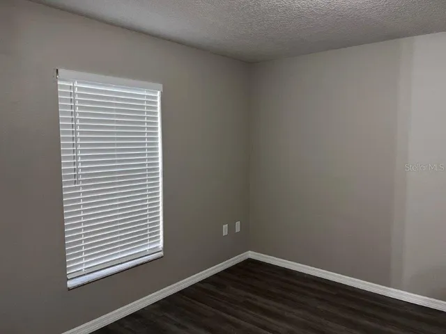 a view of a small space with wooden floor and a window