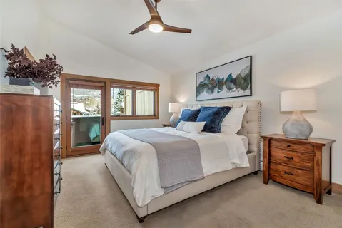 a bedroom with a bed and a painting on the wall