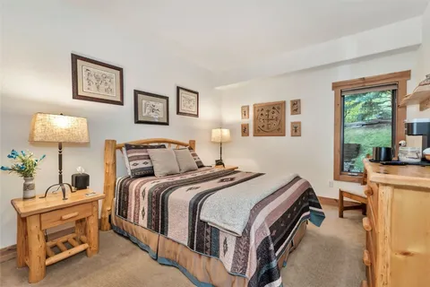 a bedroom with a bed and a table in it