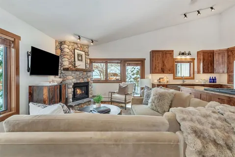 a living room with fireplace furniture and a flat screen tv