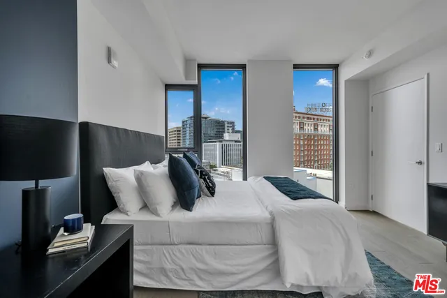 a bedroom with a bed and glass window