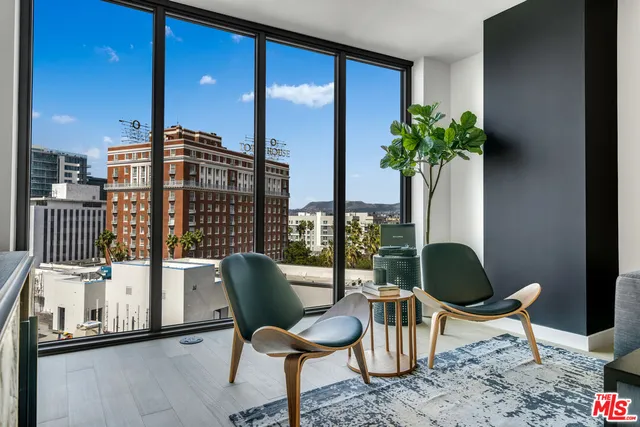 a dining room with furniture and a potted plant