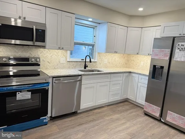 a kitchen with a sink stove and microwave