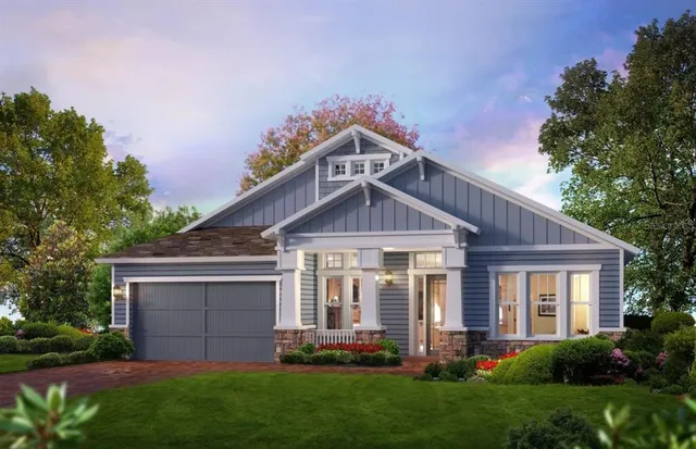 a front view of a house with a garden and plants