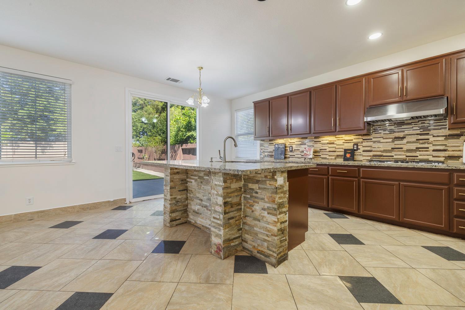 3105 Ripple Court Modesto, CA 95355 - Photo 12 of 46 a kitchen with stainless steel appliances granite countertop a stove sink and cabinets