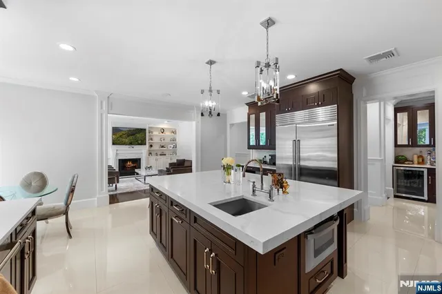 a kitchen with stainless steel appliances granite countertop a sink a stove and a refrigerator