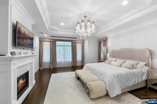 a spacious bedroom with a bed and a television