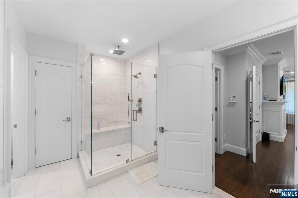 199 Whitman Street Haworth, NJ 07641 - Photo 30 of 50 a bathroom with a shower and a glass door