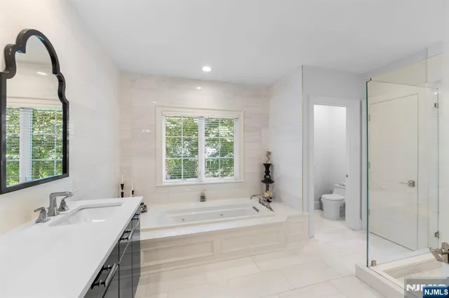 a bathroom with a shower and a glass door