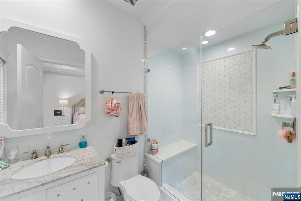 199 Whitman Street Haworth, NJ 07641 - Photo 33 of 50 a bathroom with a granite countertop sink toilet and shower