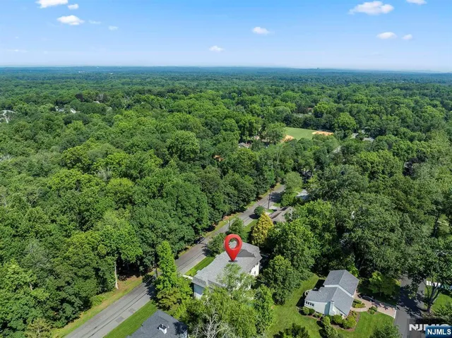 an aerial view of a house with a yard and a fountain