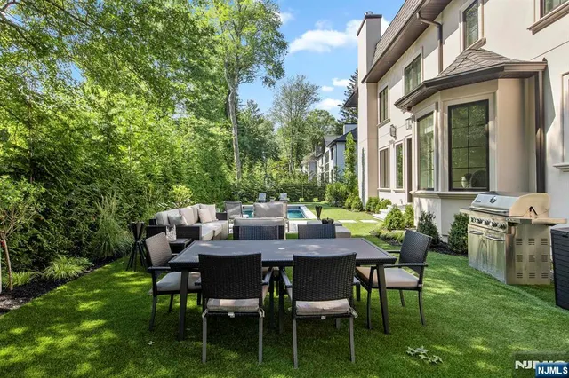 a view of a patio with table and chairs and potted plants