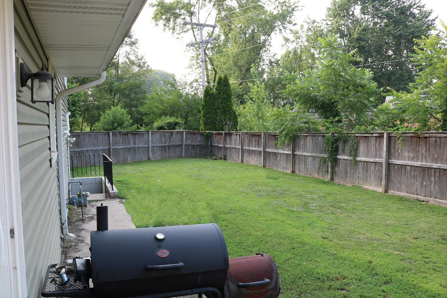 8469 Morse Court Crown Point, IN 46307 - Photo 26 of 33 a view of a backyard with couches plants and large tree