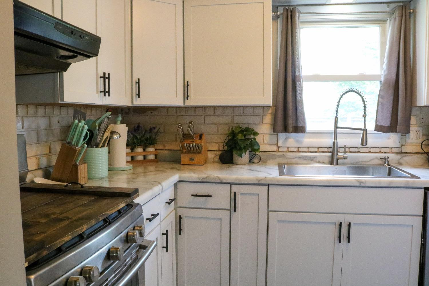 8469 Morse Court Crown Point, IN 46307 - Photo 8 of 33 a kitchen with appliances a sink and cabinets