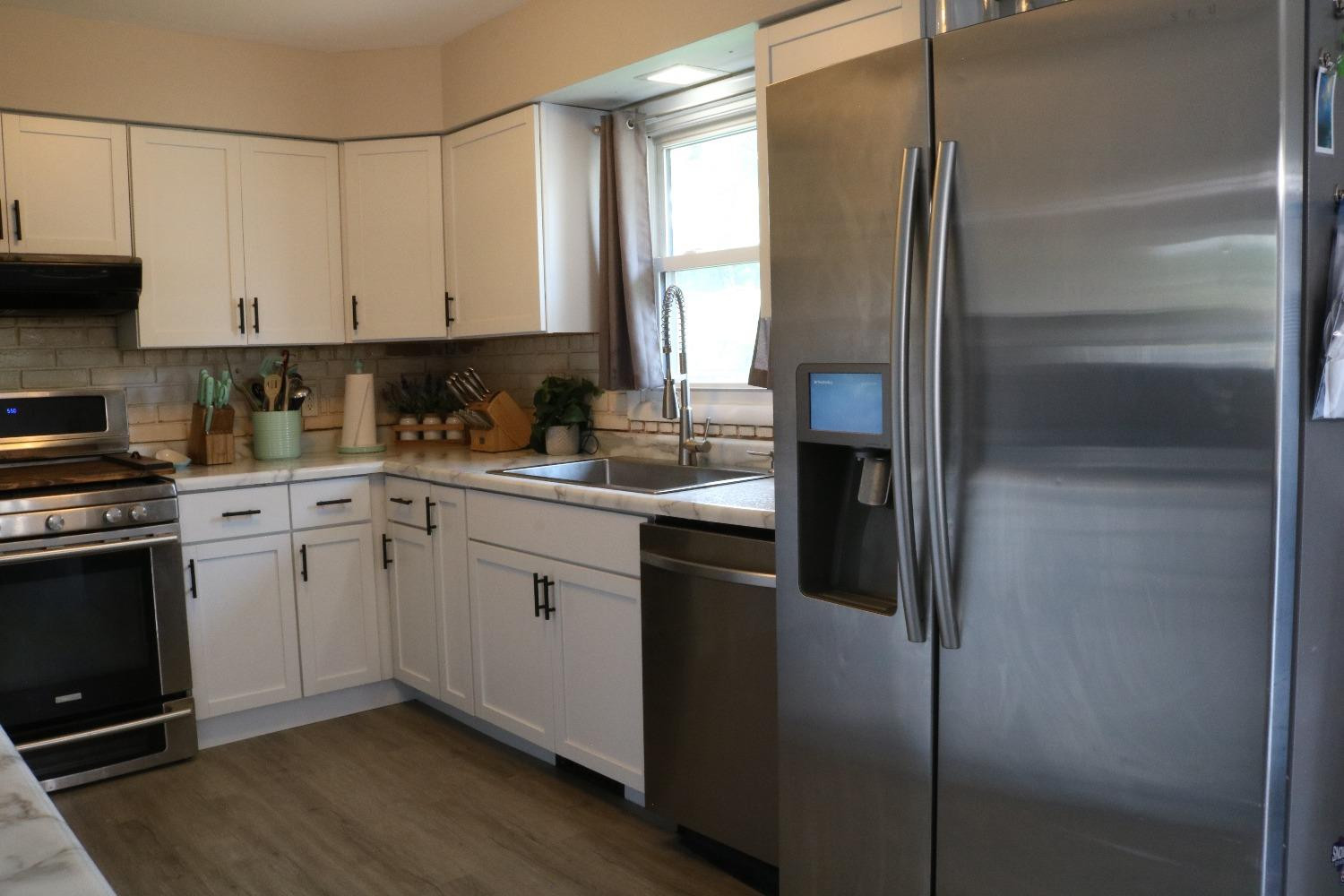 8469 Morse Court Crown Point, IN 46307 - Photo 10 of 33 a kitchen with a refrigerator sink and cabinets