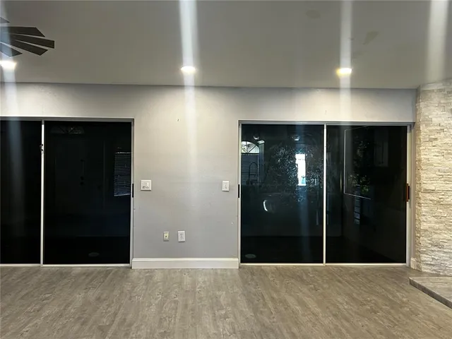 a view of hallway with stairs and wooden floor