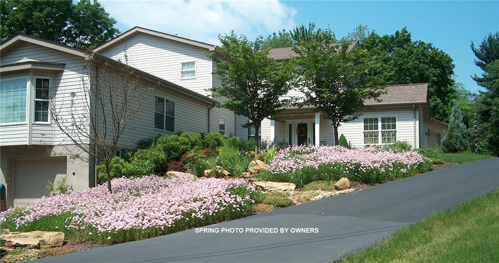 676 Deer Creek Road Valencia, PA 16059 - Photo 1 of 25 Custom home on .75 Acre built by Rossman Hensley ~ Lush landscaping in the Spring photo provided by Sellers! Water feature runs through middle of flowers!
