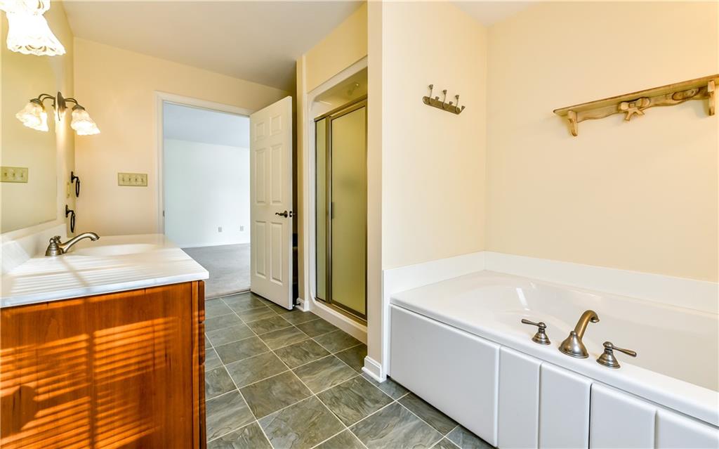 676 Deer Creek Road Valencia, PA 16059 - Photo 14 of 25 Master Bath features separate tub and shower and has second doorway to Laundry for convenience.