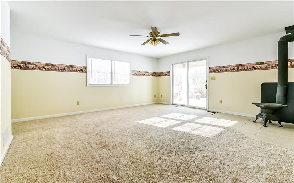 676 Deer Creek Road Valencia, PA 16059 - Photo 10 of 25 Family Room features sliding glass doors to patio. First floor Laundry and steps to 2nd floor are around corner to left.