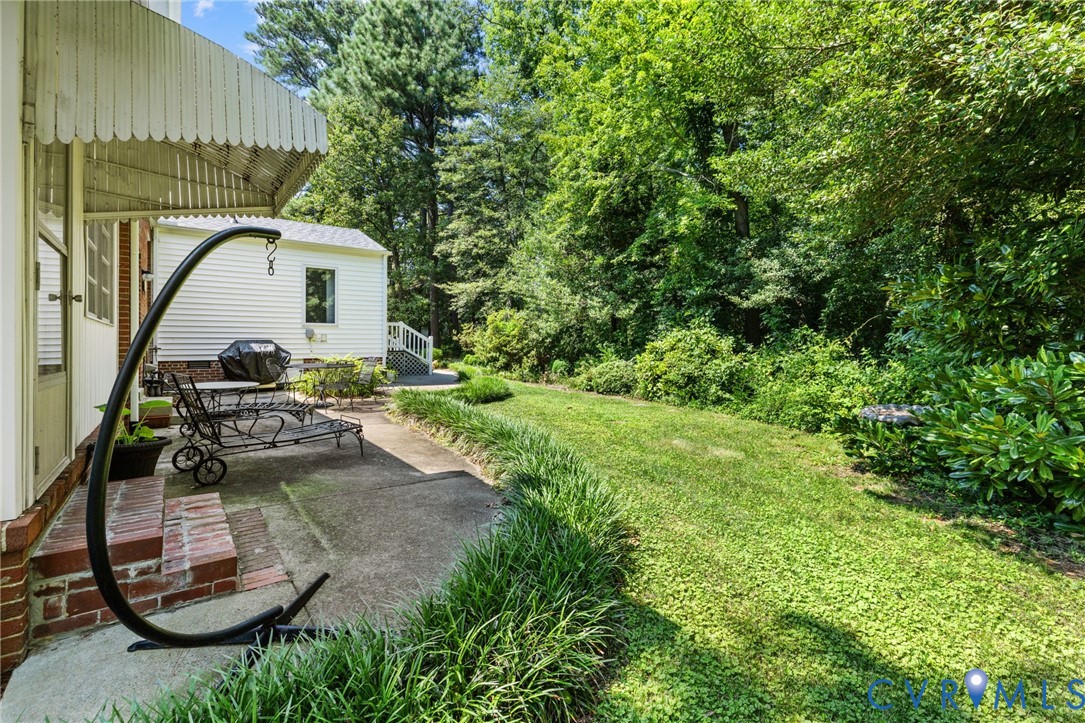 8208 Michael Road Henrico, VA 23229 - Photo 2 of 29 Expansive green lawn with mature trees, offering a