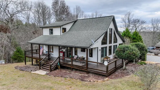 a view of house with a deck and a patio