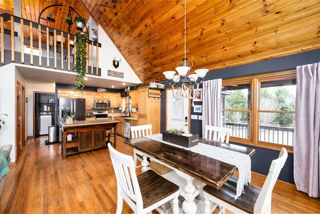 a living room with stainless steel appliances granite countertop a stove and wooden floor
