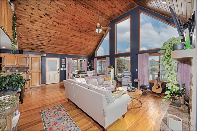 a view of a patio with couches table and chairs and potted plants