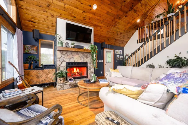 a living room with furniture a flat screen tv and a fireplace
