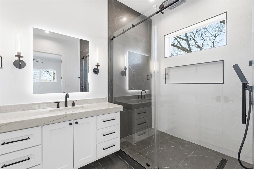 6257 Turner Way Dallas, TX 75230 - Photo 31 of 39 a bathroom with a granite countertop sink mirror and a shower