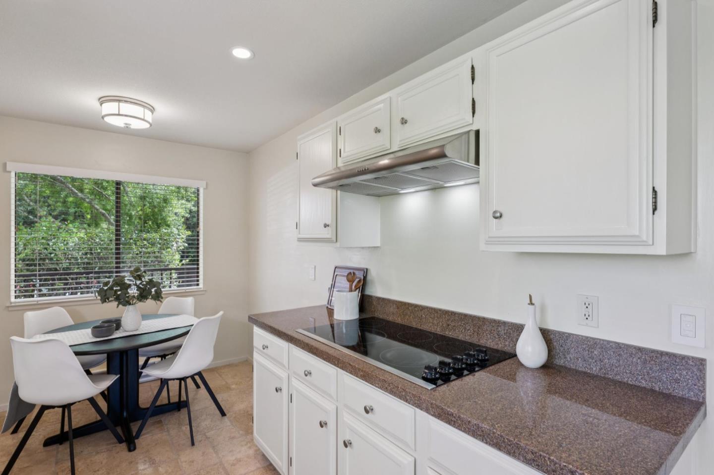 8 Shepherds Knoll Pebble Beach, CA 93953 - Photo 15 of 47 a kitchen with stainless steel appliances white cabinets and wooden floor