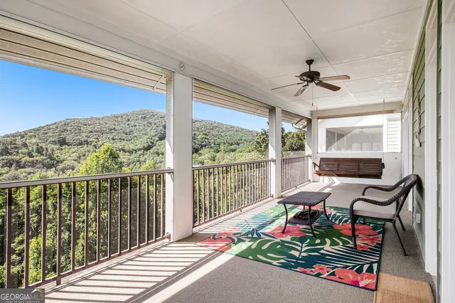 a balcony with furniture and wooden floor
