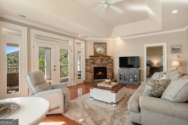 a living room with furniture a flat screen tv and a fireplace