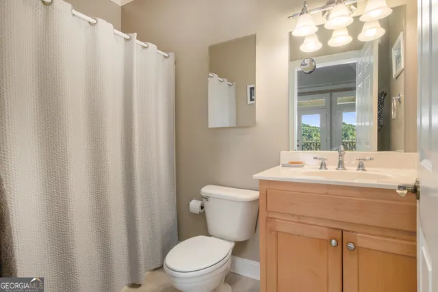 a bathroom with a sink a toilet and a mirror