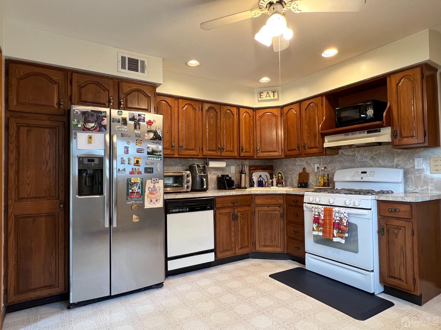 4 Crescent Road Edison, NJ 08817 - Photo 8 of 24 a kitchen with stainless steel appliances granite countertop a refrigerator a stove a sink and a microwave