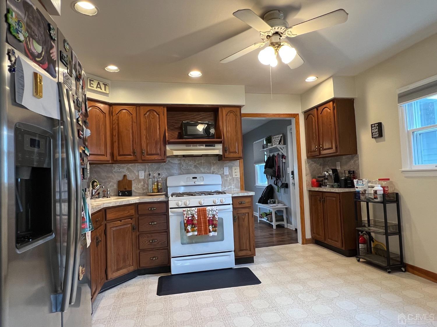 4 Crescent Road Edison, NJ 08817 - Photo 10 of 24 a open kitchen with cabinets a sink and a stove top oven with wooden floor