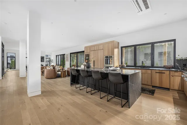a living room with fireplace furniture and a large window