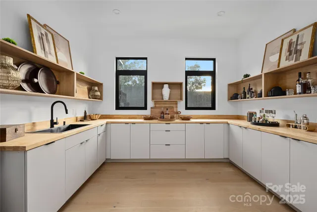 a kitchen with granite countertop a sink and cabinets