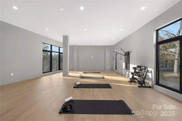 a room with gym equipment and large window