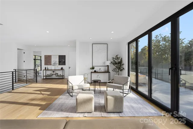 a dining room with wooden floor and glass windows