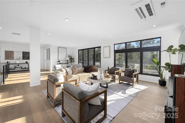 a living room with furniture and large windows