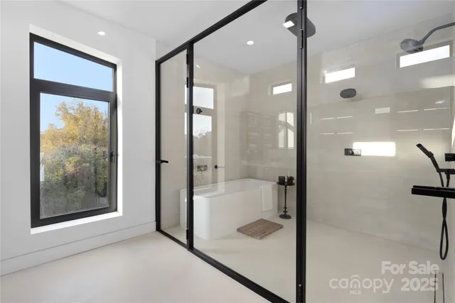 a bathroom with a glass shower door and a shower